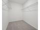 A bright walk-in closet features built-in wire shelving on white walls and a gray carpet at 2518 Linda Knoll Ln, Bartow, FL 33830