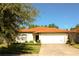 Charming single story home with a well-manicured lawn and an orange tile roof under a blue sky at 2788 Roccella Ct, Kissimmee, FL 34747