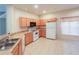 Kitchen features wood cabinets, white appliances, and tile flooring at 2788 Roccella Ct, Kissimmee, FL 34747