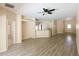 Open-concept living room with wood-look floors and view of the kitchen counter at 2788 Roccella Ct, Kissimmee, FL 34747