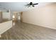 A spacious living room features wood-look floors, a ceiling fan, and neutral paint at 2788 Roccella Ct, Kissimmee, FL 34747
