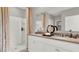 Well-lit bathroom featuring double sinks, modern fixtures, and a walk-in shower at 2825 Jamaica Way, Haines City, FL 33844