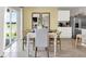 Dining room featuring a white table, seating for six and sliding glass door leading to outdoor patio at 2825 Jamaica Way, Haines City, FL 33844