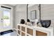 Inviting entryway featuring a white accent cabinet, modern mirror, and stylish decor at 2825 Jamaica Way, Haines City, FL 33844