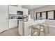 Bright kitchen with stainless steel appliances, white cabinets and a breakfast bar with three stools at 2825 Jamaica Way, Haines City, FL 33844