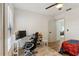 Bedroom featuring laminate wood floors, ceiling fan, closet and desk at 2900 S Semoran Blvd # 4, Orlando, FL 32822