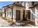 Charming townhome entrance with landscaped garden, modern exterior light fixture, and wood accents at 2900 S Semoran Blvd # 4, Orlando, FL 32822