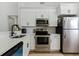 Modern kitchen featuring stainless steel appliances, white cabinets and stone countertops at 2900 S Semoran Blvd # 4, Orlando, FL 32822