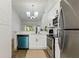 Stylish kitchen featuring modern stainless steel appliances, white cabinets, and natural light at 2900 S Semoran Blvd # 4, Orlando, FL 32822