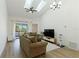 Bright living room featuring vaulted ceilings, skylights, modern fan and neutral decor at 2900 S Semoran Blvd # 4, Orlando, FL 32822
