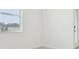 Bright bedroom featuring white walls, a window with blinds, and a glass door to the outside at 2948 Wild Olive Dr, St Cloud, FL 34772
