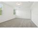 Bright bedroom with a neutral carpet, a ceiling fan, and a large window at 2948 Wild Olive Dr, St Cloud, FL 34772