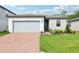 Charming single-story home featuring a brick driveway, stone accents, and well-maintained landscaping at 2948 Wild Olive Dr, St Cloud, FL 34772