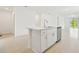 Open kitchen with stainless steel dishwasher and sink, an island with bar seating at 2948 Wild Olive Dr, St Cloud, FL 34772