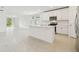 Open kitchen with stainless steel appliances, an island with sink, and adjacent living space at 2948 Wild Olive Dr, St Cloud, FL 34772