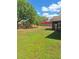 Expansive backyard featuring lush green grass and a brick wall, perfect for outdoor activities at 3125 Timucua Cir, Orlando, FL 32837