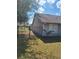 Backyard of a home featuring a small palm tree and a wrought iron fence at 3125 Timucua Cir, Orlando, FL 32837