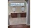 Bathroom with a double sink vanity, granite counters, tiled floors, and large decorative mirrors at 3125 Timucua Cir, Orlando, FL 32837
