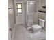 Bathroom featuring a glass enclosed shower, white tiling, and a door to the outside at 3125 Timucua Cir, Orlando, FL 32837