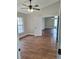 A bright bedroom featuring wood floors, a ceiling fan, and natural light at 3125 Timucua Cir, Orlando, FL 32837