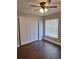 Comfortable bedroom with a closet, wood-look flooring, and a window at 3125 Timucua Cir, Orlando, FL 32837