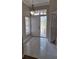 Bright foyer featuring tiled flooring, a decorative light fixture, and a window with blinds for natural light at 3125 Timucua Cir, Orlando, FL 32837