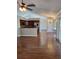 Open-concept kitchen with stainless steel appliances, hardwood floors, and seamless flow to the adjacent dining and living areas at 3125 Timucua Cir, Orlando, FL 32837