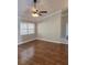Spacious living room with a ceiling fan, ample natural light, and wood-look flooring at 3125 Timucua Cir, Orlando, FL 32837