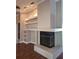 Cozy living room featuring a fireplace, built-in shelves, and elegant crown molding at 3125 Timucua Cir, Orlando, FL 32837