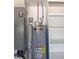 A modern State water heater with an energy guide in a utility area with white shelving at 3125 Timucua Cir, Orlando, FL 32837