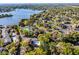 Aerial view of a condo community with pool, tennis courts, lake views and lush tree coverage at 366 Waterside Dr # 102, Altamonte Springs, FL 32701