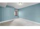 Cozy bedroom with neutral carpet, window, and fresh turquoise-painted walls at 366 Waterside Dr # 102, Altamonte Springs, FL 32701