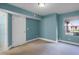 Cozy bedroom with neutral carpet and fresh turquoise-painted walls at 366 Waterside Dr # 102, Altamonte Springs, FL 32701