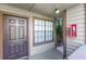 Cozy entrance to unit 102 features a dark door and adjacent window for natural light and curb appeal at 366 Waterside Dr # 102, Altamonte Springs, FL 32701