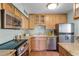 Charming kitchen features wood cabinets, stainless steel appliances, and granite countertops at 366 Waterside Dr # 102, Altamonte Springs, FL 32701
