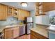 Charming kitchen with wood cabinets, granite countertops, and stainless steel refrigerator at 366 Waterside Dr # 102, Altamonte Springs, FL 32701