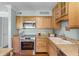Charming kitchen featuring wood cabinets, granite countertops, and stainless steel oven at 366 Waterside Dr # 102, Altamonte Springs, FL 32701
