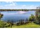 Picturesque lake view with trees and sky reflecting in the calm waters from the shoreline at 366 Waterside Dr # 102, Altamonte Springs, FL 32701