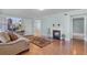 Inviting living room featuring hardwood floors, a cozy fireplace, and plenty of natural light at 366 Waterside Dr # 102, Altamonte Springs, FL 32701