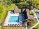 An aerial view of the community pool surrounded by well-maintained landscaping and a clubhouse at 366 Waterside Dr # 102, Altamonte Springs, FL 32701