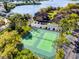 Aerial view of tennis courts, parking, and buildings with a lake in the background at 366 Waterside Dr # 102, Altamonte Springs, FL 32701