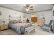 Comfortable bedroom with neutral carpet, decorative wallpaper, and a ceiling fan at 398 Troon Ct, Winter Haven, FL 33884