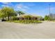 Exterior view of a community center featuring lush landscaping and ample parking at 398 Troon Ct, Winter Haven, FL 33884