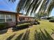 Charming brick home featuring a well-manicured lawn and beautiful landscaping at 398 Troon Ct, Winter Haven, FL 33884