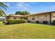 Charming single-story brick home with a well-manicured lawn and mature landscaping at 398 Troon Ct, Winter Haven, FL 33884
