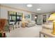 Cozy living room with plush carpeting, comfortable seating, and plenty of natural light at 398 Troon Ct, Winter Haven, FL 33884