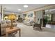 Bright living room with neutral carpet, comfortable seating, and a mirrored accent wall at 398 Troon Ct, Winter Haven, FL 33884