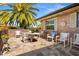 Relaxing patio with brick pavers, comfortable seating, surrounded by lush landscaping at 398 Troon Ct, Winter Haven, FL 33884
