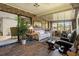 Bright sunroom with tile floors, comfortable seating, and views of the backyard at 398 Troon Ct, Winter Haven, FL 33884