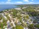 An expansive aerial view showcasing the neighborhood near the water, dotted with mature trees and residential homes at 427 N Lakeview Ave, Winter Garden, FL 34787